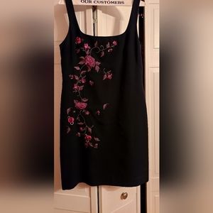 Black dress with embroidered and raised ribbon purple pink flowers.